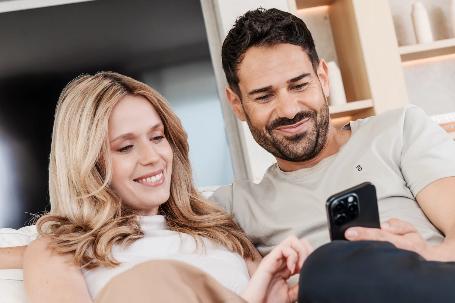 Young couple looking at app on smartphone